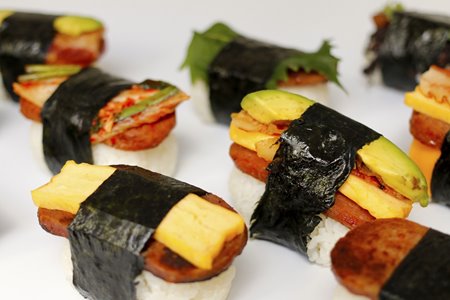Variety of spam musubis with different toppings including avocado, egg, shiso, & kim chee from Musubi Cafe Iyasume, which will be opening soon at Waikiki Beach Walk.