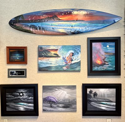 Various pieces of ocean-themed wall art, including a painted surfboard
