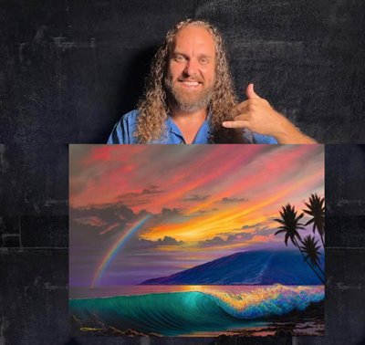 Chris Sebo holding up an original painting of a beach at sunset