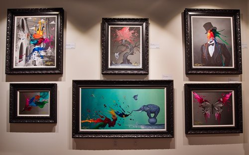 6 paintings on a wall at Park West Fine Art Museum & Gallery in Waikiki.