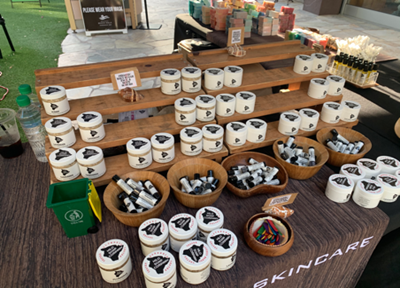 Jars of body products lined up on a table for sale at the Waikiki Beach Walk farmers market