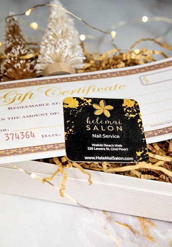 Black & yellow Hele Mai Salon Nail Service card placed on a gift certificate