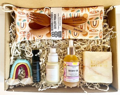 Gift box with a handmade rainbow keychain, 3 different body products, soap, & a reusable utensil set.