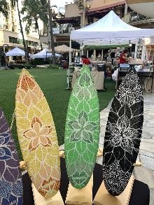 Mini colored surfboards with floral pattern at Waikiki Beach Walk's farmers market