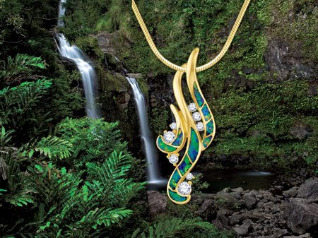Gold waterfall pendant with opal inlays & diamonds in front of a real waterfall in Hawaii.