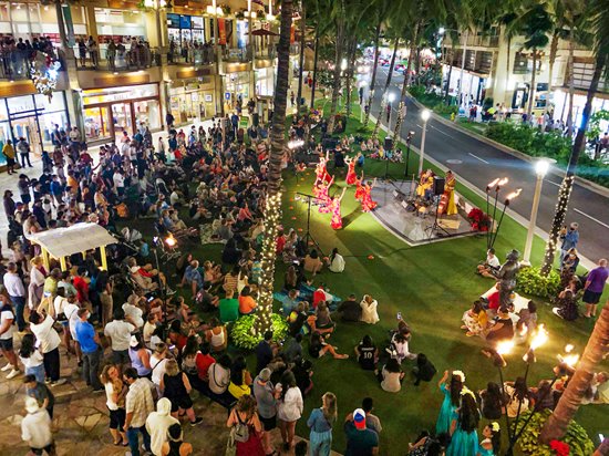 View from the 2nd floor of a crowd watching a hula performance on the lawn at Waikiki Beach Walk