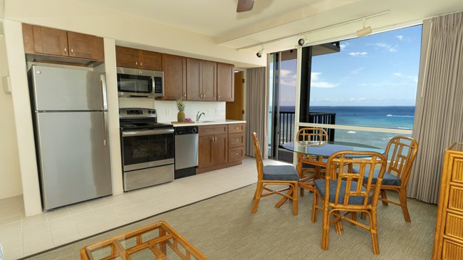 Kitchen & dining area of the suite with a view of the ocean in the back.