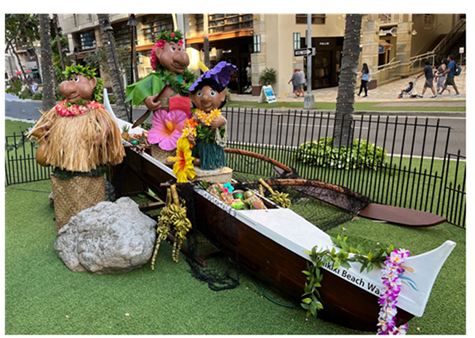 Another angle of the Menehune installation, featuring 3 Menehune statues riding aboard the wooden canoe.