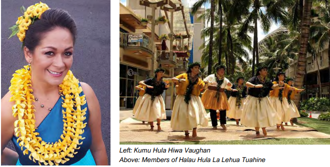 Kumu Hiwa Vaughan draped in yellow lei on the left. On the right, members of Halau Hula La Lehua Tuahine dance in formation.