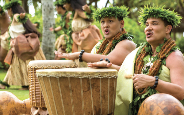 Men in traditional Hawaiian hula dress performing a song