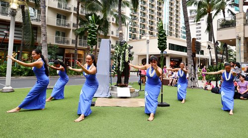 Hula dancers performing around the Gabby Pahinui statue.