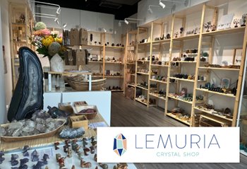 A crystal shop interior with shelves displaying various types of colorful crystals.